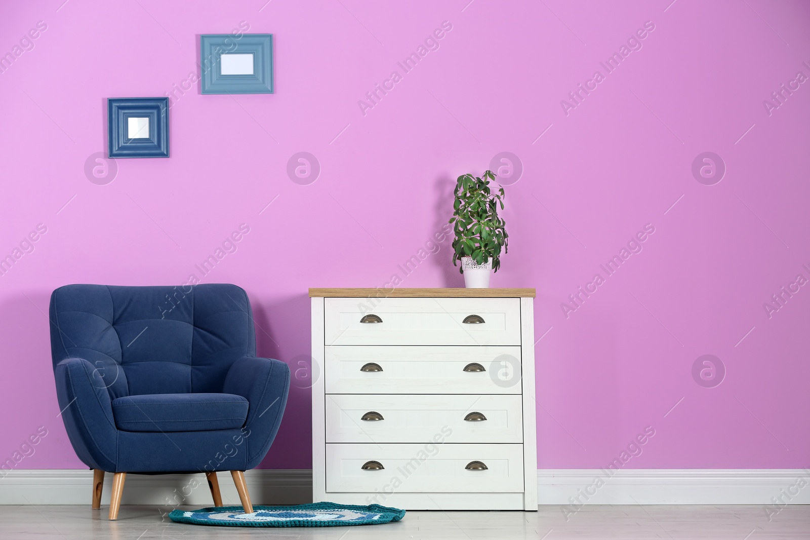 Photo of Stylish room interior with chest of drawers and space for text