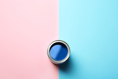 Open paint can and space for text on color background, top view