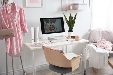 Photo of Comfortable workplace with computer on desk in home office