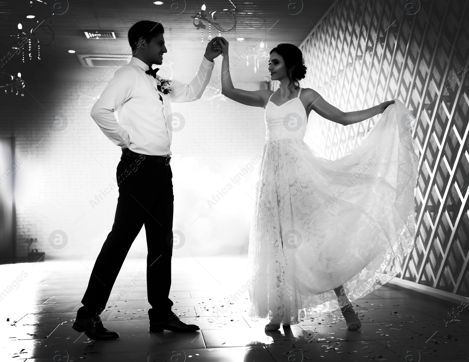 Image of Happy newlywed couple dancing together in festive hall