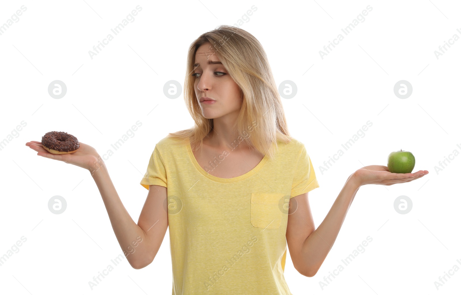 Photo of Woman choosing between doughnut and healthy apple on white background