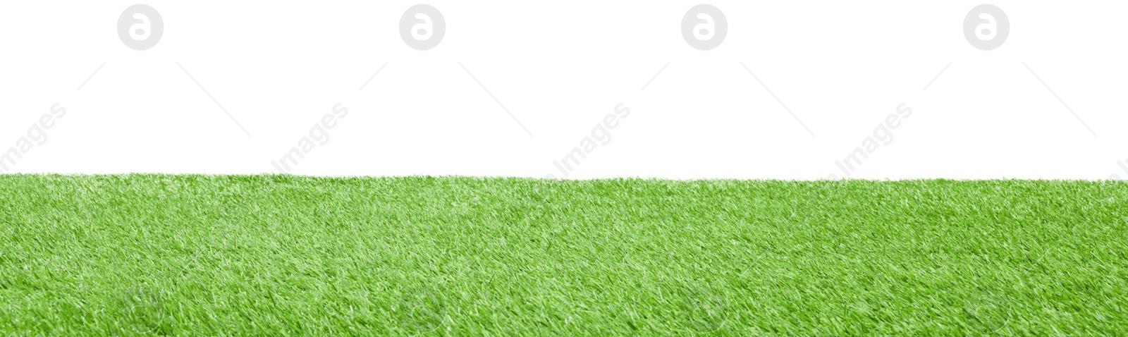 Photo of Green artificial grass surface isolated on white