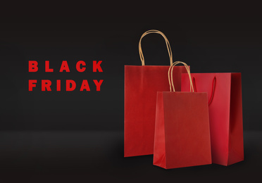 Image of Paper shopping bags on color background. Black friday