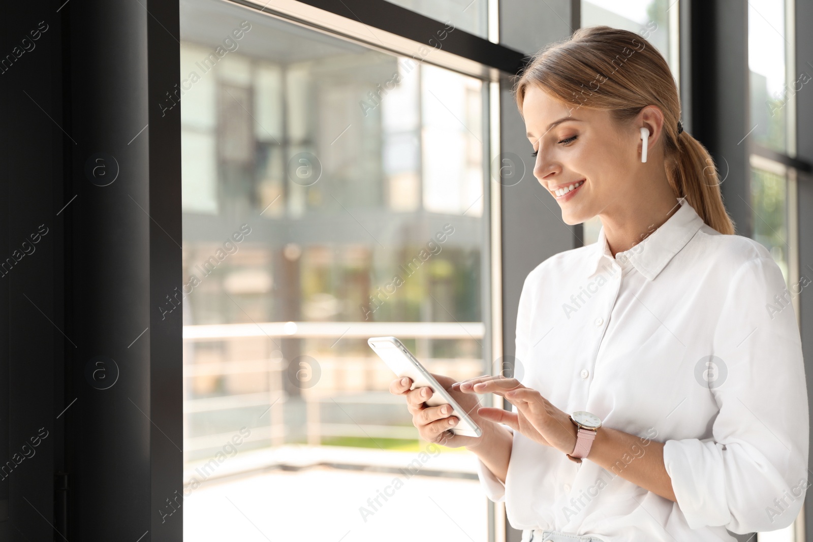 Photo of Portrait of female business trainer with smartphone indoors