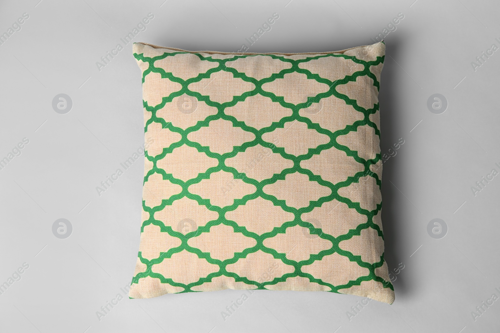 Photo of Soft decorative pillow on light background