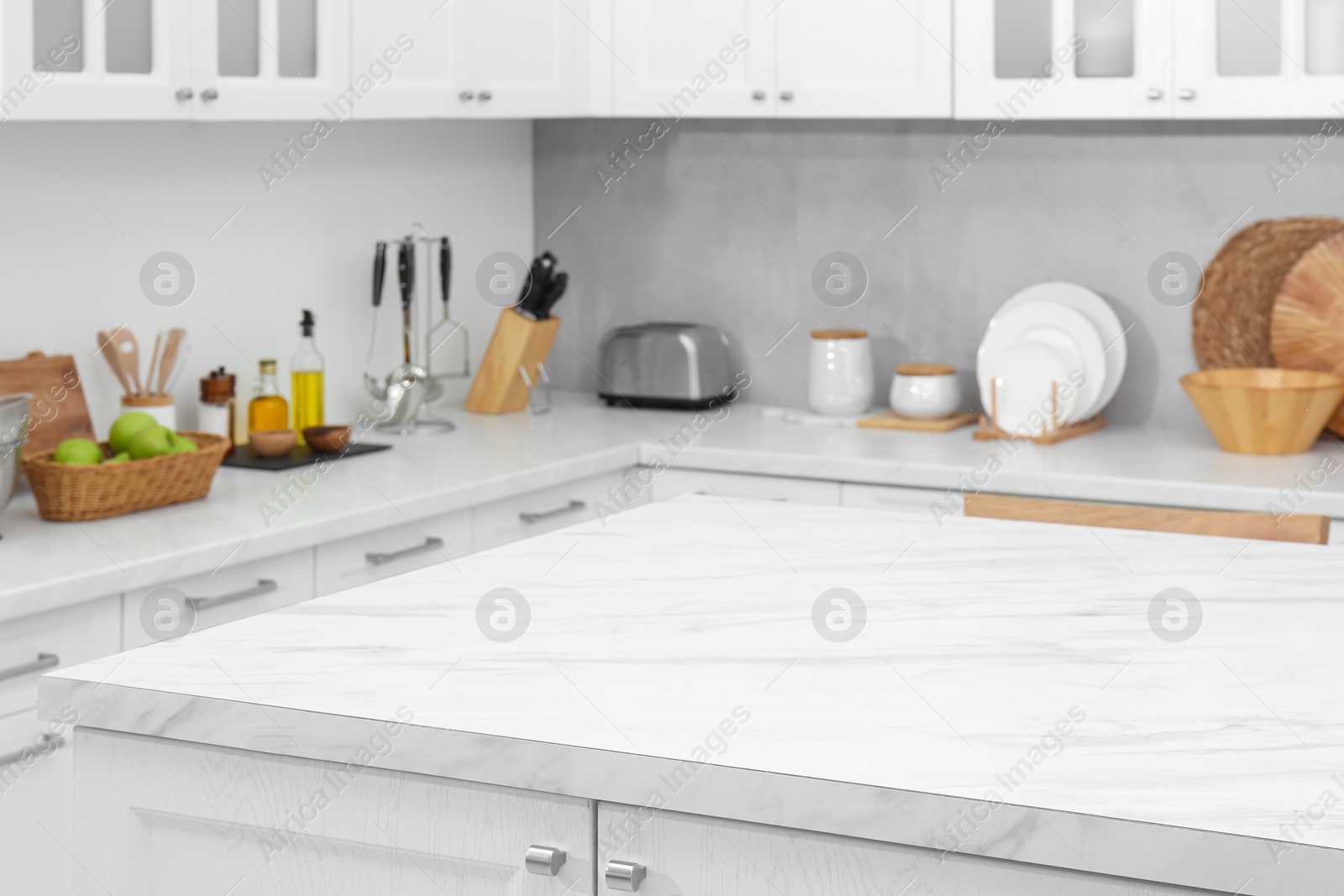 Photo of Stylish white marble table in kitchen. Interior design