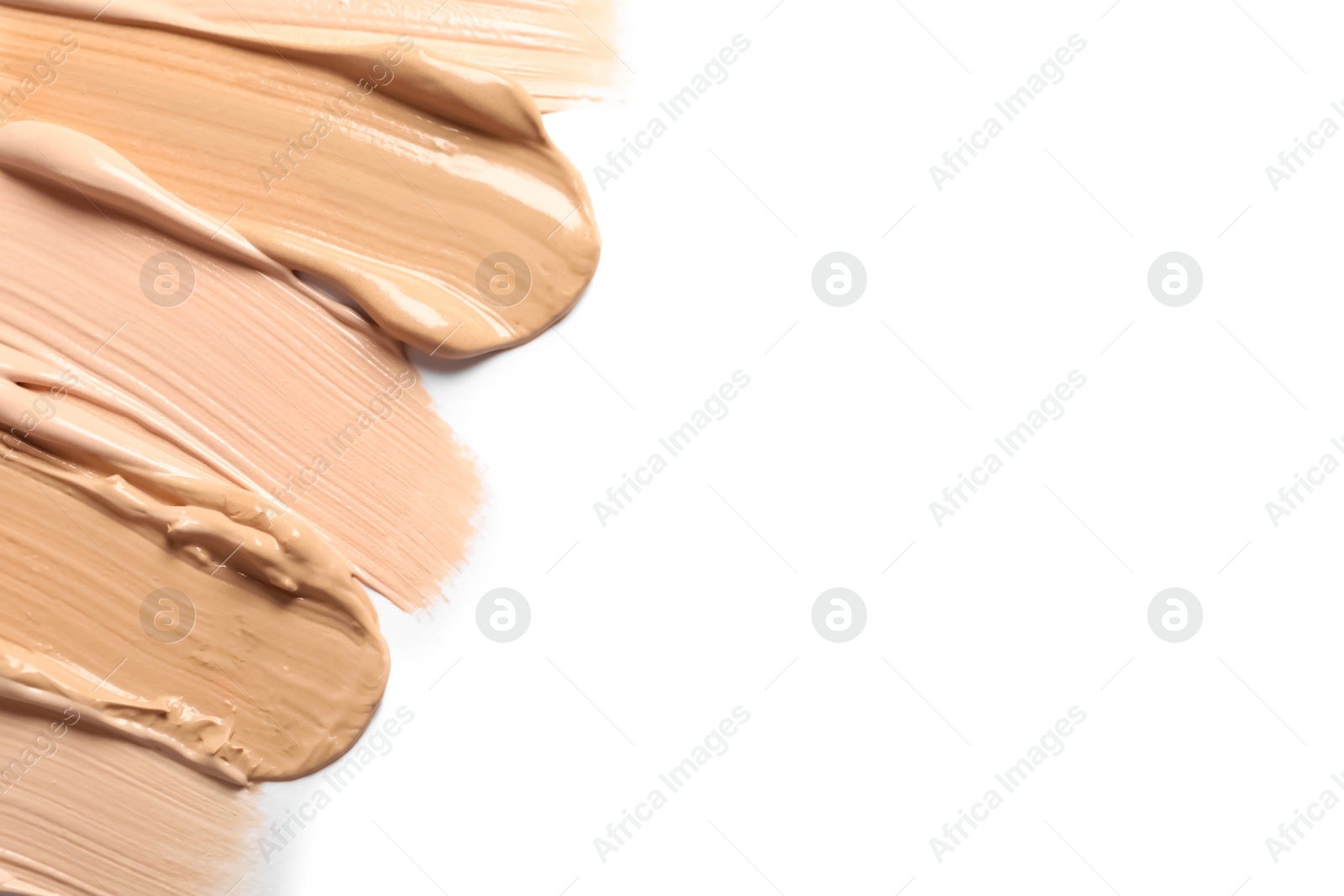 Photo of Samples of skin foundation on white background, closeup. Space for text