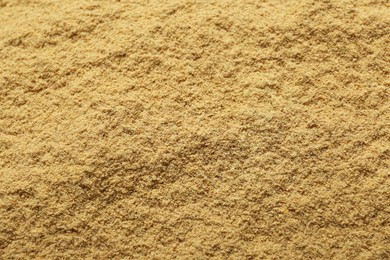 Photo of Aromatic mustard powder as background, top view