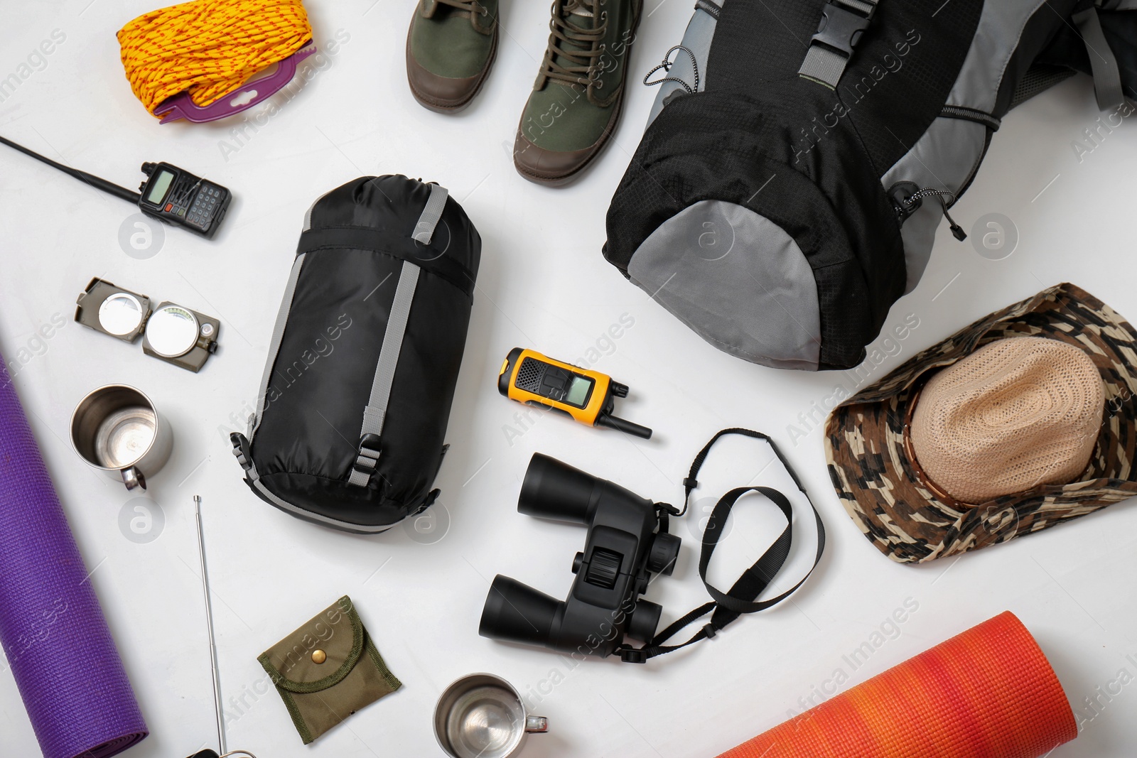 Photo of Flat lay composition with camping equipment on white background