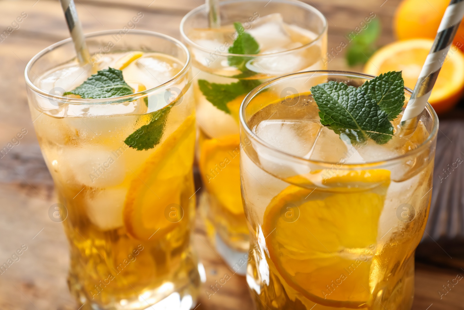 Photo of Delicious refreshing drink with orange slices on table, closeup