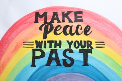 Photo of Painted rainbow and life-affirming phrase Make Peace With Your Past on white background