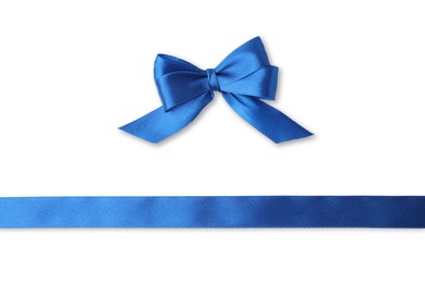 Blue satin ribbon and bow on white background, top view