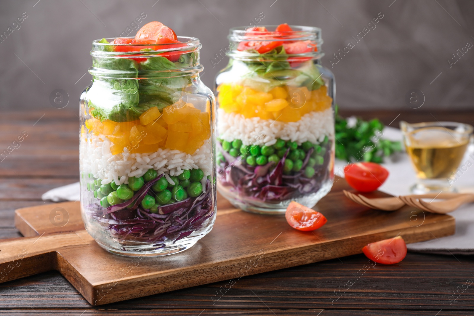 Photo of Healthy salad in glass jars on wooden table