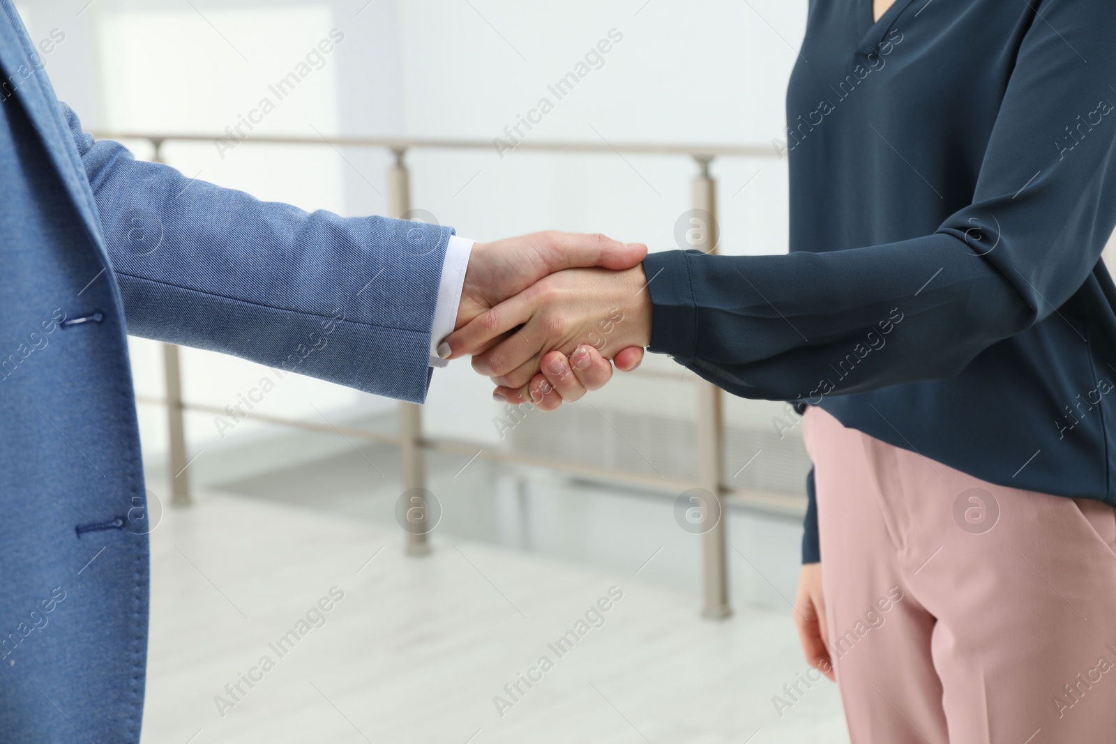 Photo of Real estate agent shaking hands with client in new apartment, closeup