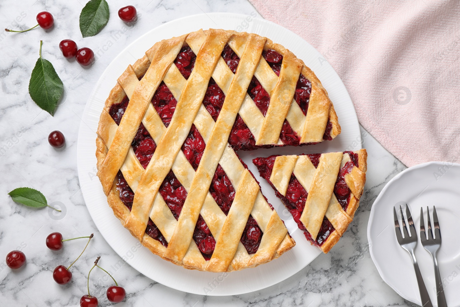 Photo of Delicious fresh cherry pie served on white marble table, flat lay