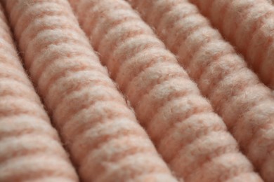 Beautiful pale pink knitted fabric as background, closeup