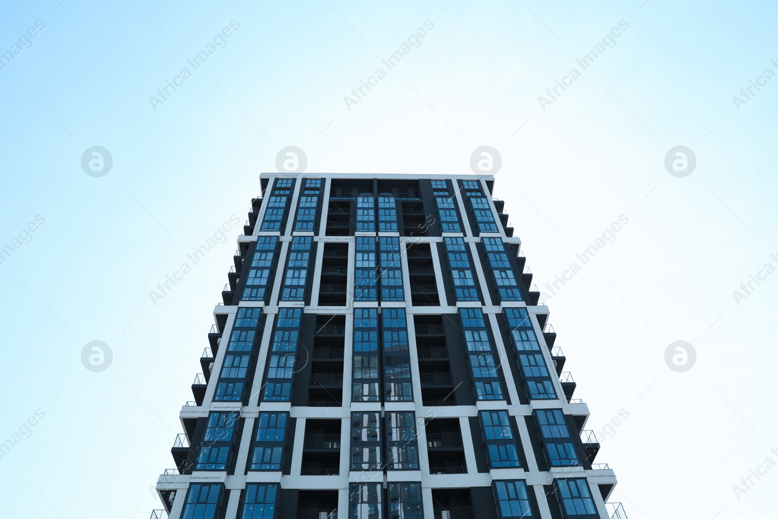 Photo of Low angle view of modern building against blue sky