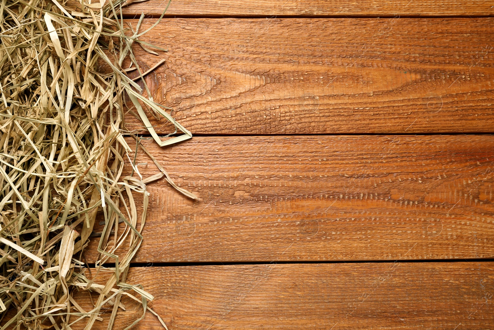 Photo of Dried hay on wooden background, flat lay. Space for text