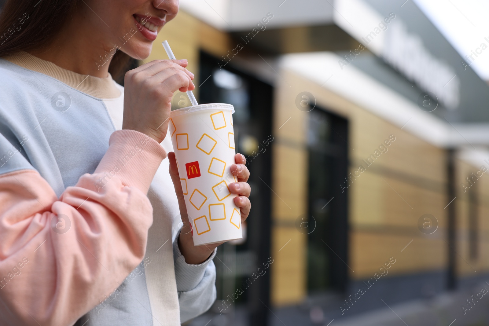 Photo of Lviv, Ukraine - September 26, 2023: Woman with McDonald's drink outdoors, closeup. Space for text