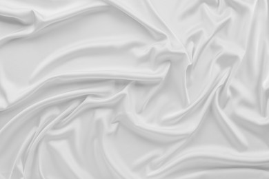 Photo of Texture of white silk ripple fabric as background, top view