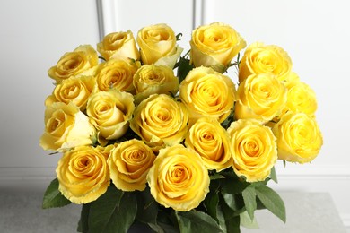 Photo of Beautiful bouquet of yellow roses on table, closeup