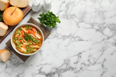 Photo of Bowl of delicious turnip soup on white marble table, flat lay. Space for text