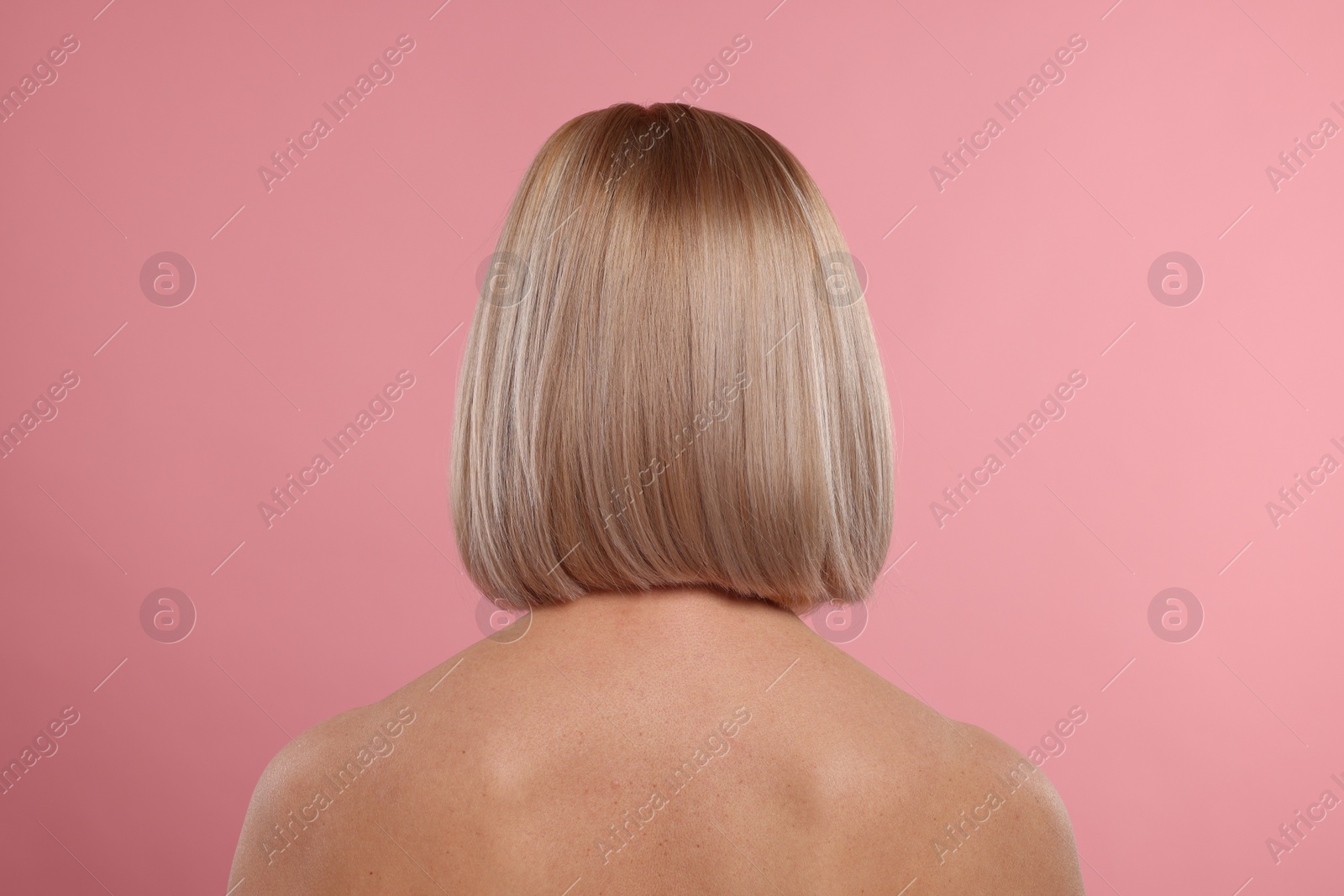 Photo of Woman with healthy skin on pink background, back view