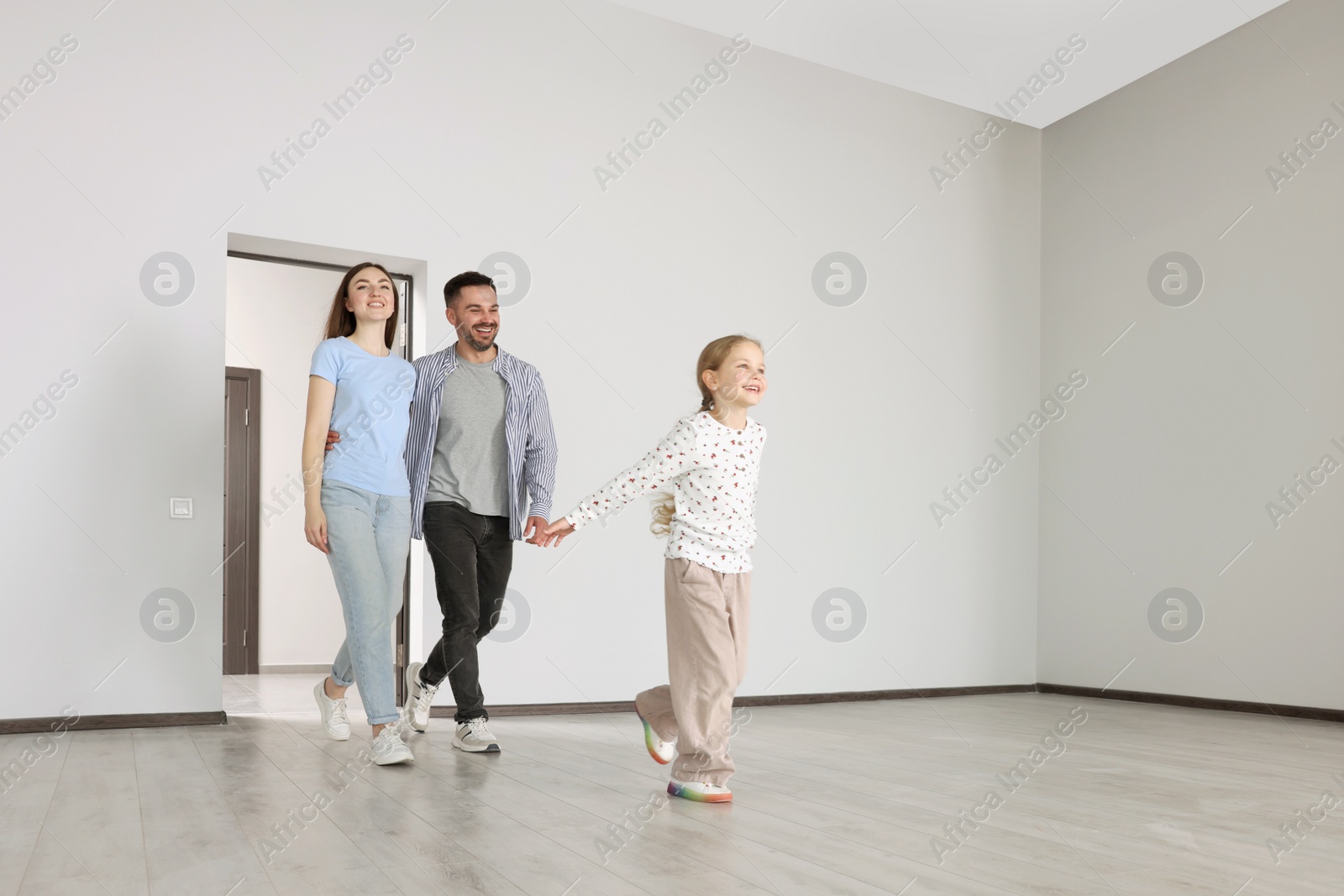 Photo of Happy family entering in their new apartment on moving day. Space for text