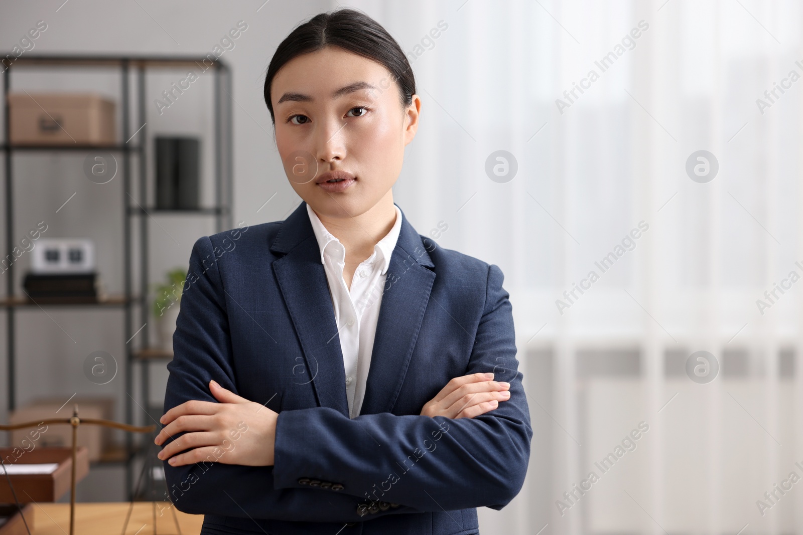 Photo of Portrait of notary with crossed arms in office