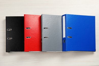 Photo of Office folders on wooden table, flat lay