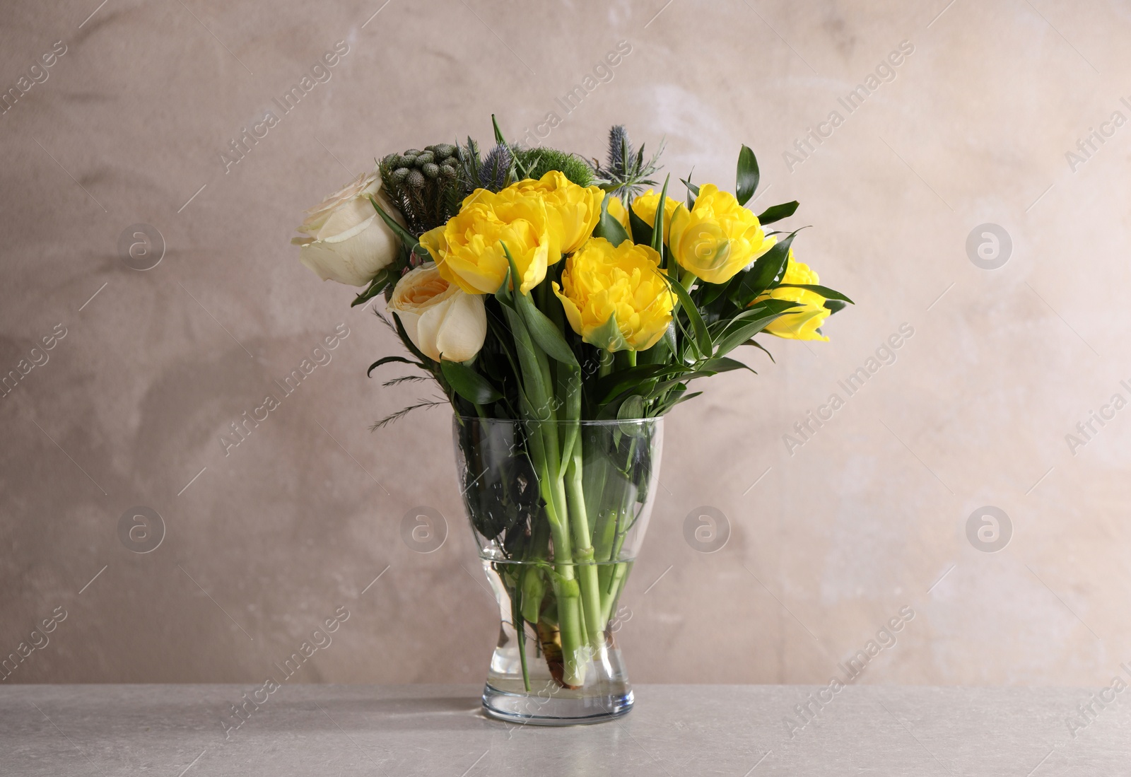 Photo of Beautiful bouquet with peony tulips on table against grey background