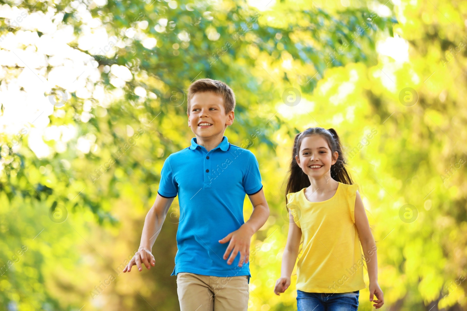 Photo of Cute little children playing together outdoors on sunny day