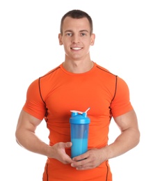 Photo of Athletic young man with protein shake on white background