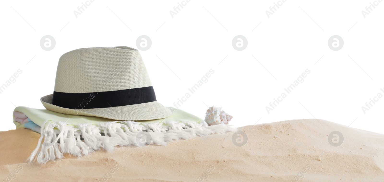 Photo of Folded towel, hat and shell on sand against white background, space for text. Beach objects