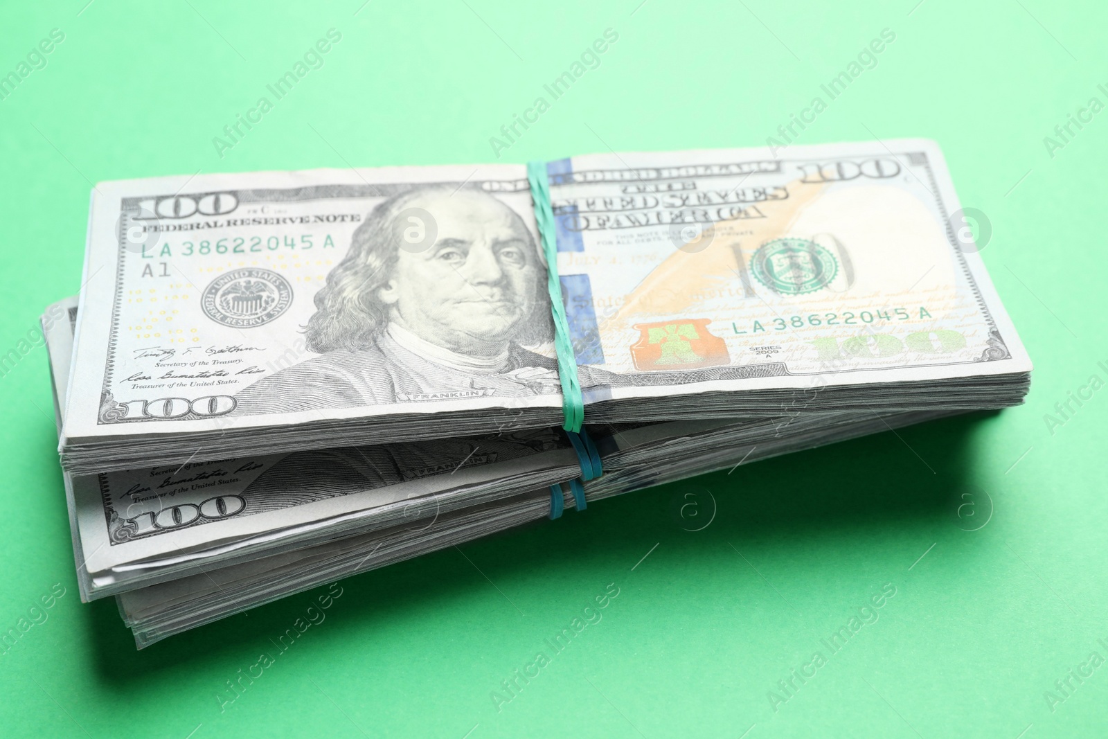 Photo of Many dollar banknotes on green background. American national currency