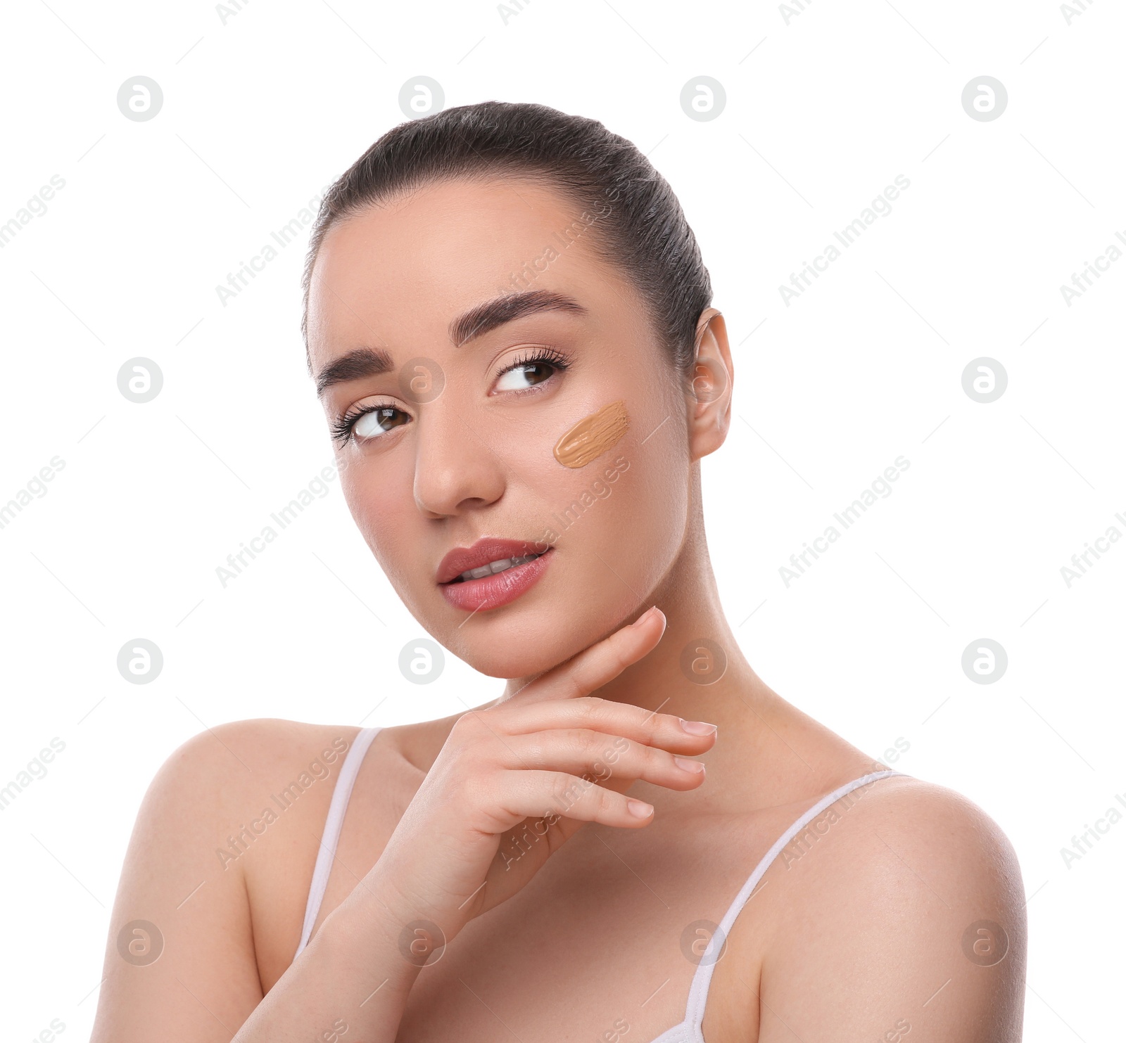 Photo of Woman with swatch of foundation on face against white background