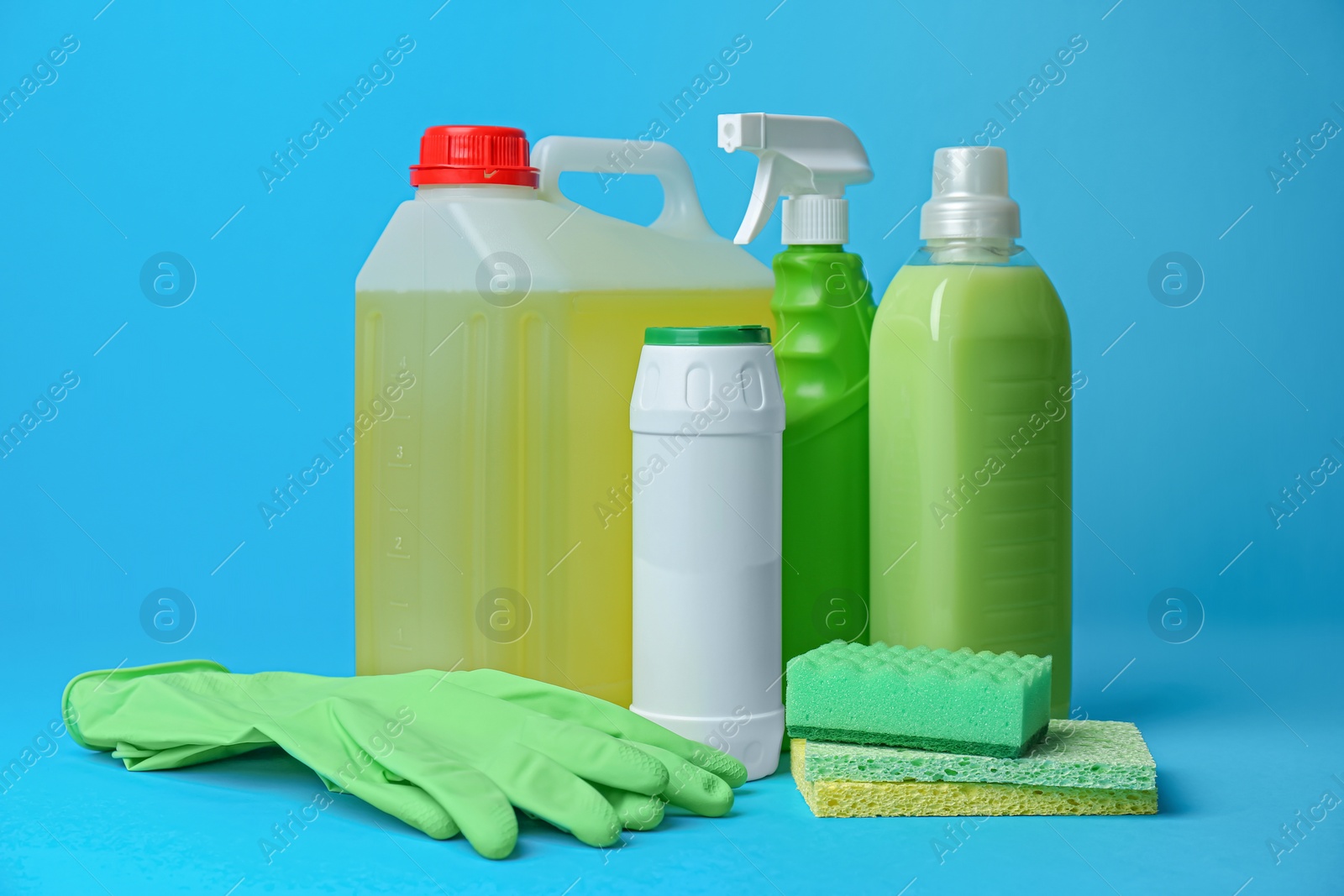 Photo of Cleaning supplies and tools on light blue background