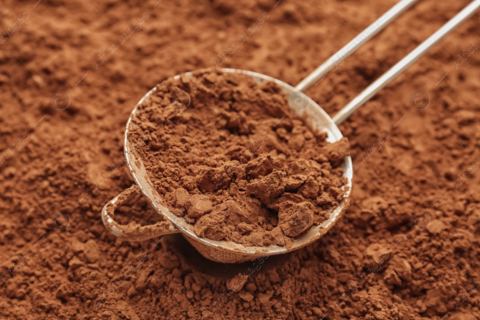 Photo of Sieve with cocoa powder, closeup