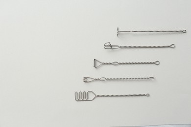 Set of logopedic probes for speech therapy on light grey background, flat lay. Space for text