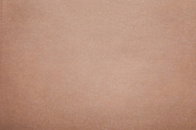 Photo of Texture of brown baking paper as background, top view