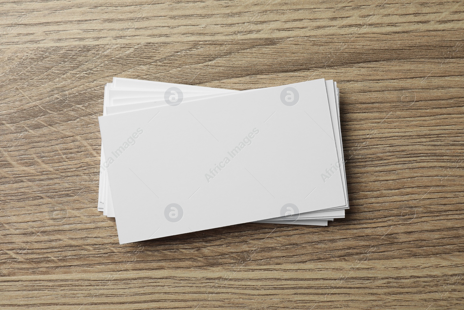 Photo of Blank business cards on wooden table, top view. Mockup for design