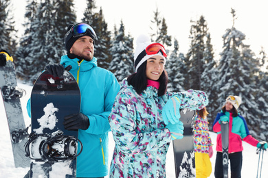 Photo of Happy couple with equipment at ski resort. Winter vacation