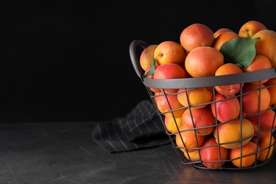 Delicious fresh ripe apricots on grey table. Space for text