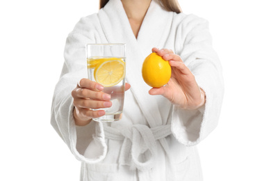 Photo of Young woman with glass of lemon water on white background, closeup