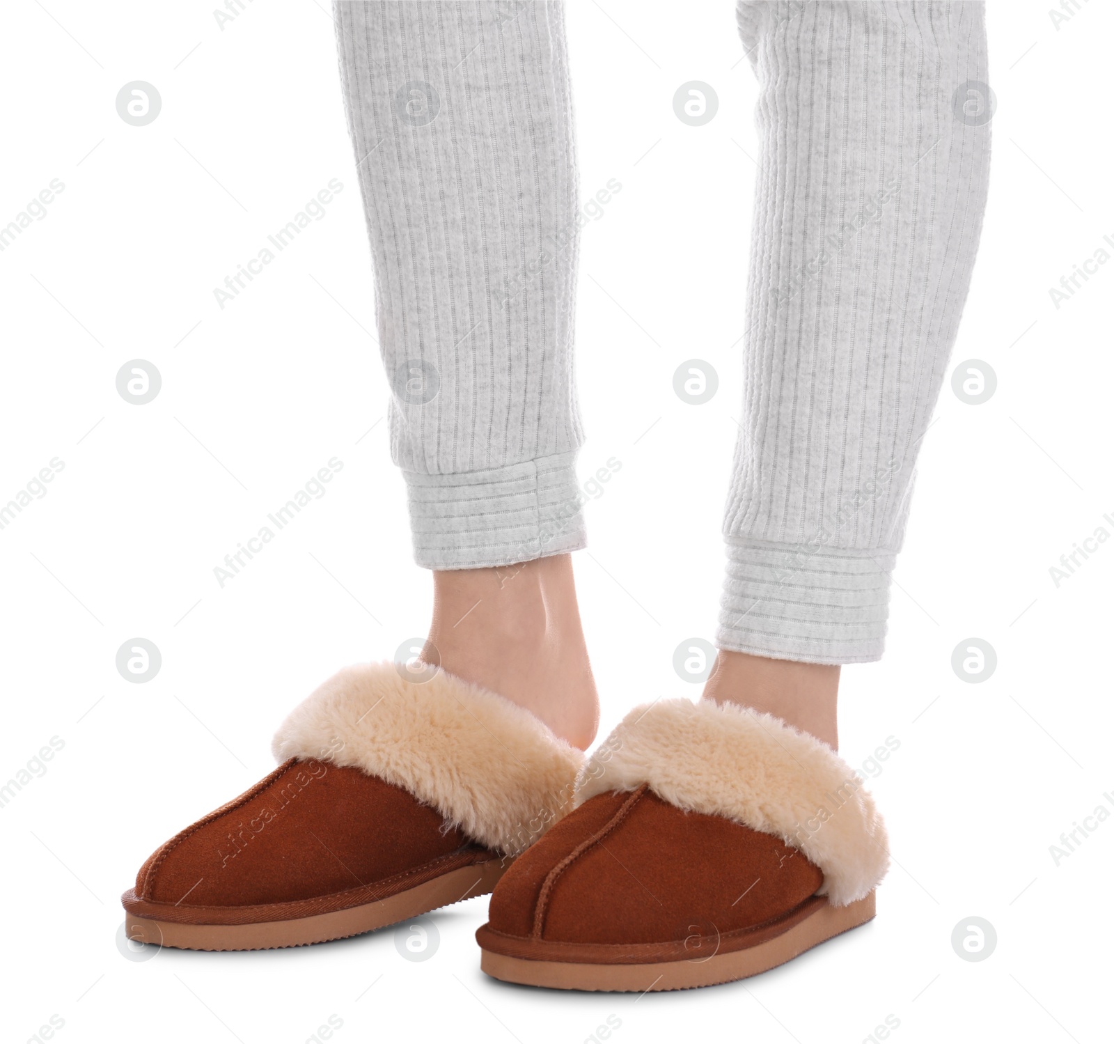 Photo of Woman in warm soft slippers on white background, closeup