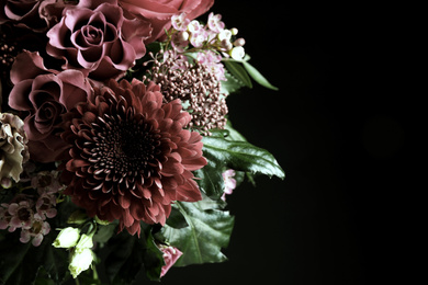 Beautiful bouquet of different flowers on black background, space for text. Floral card design with dark vintage effect