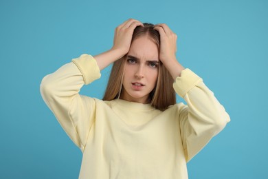 Photo of Portrait of resentful woman on light blue background