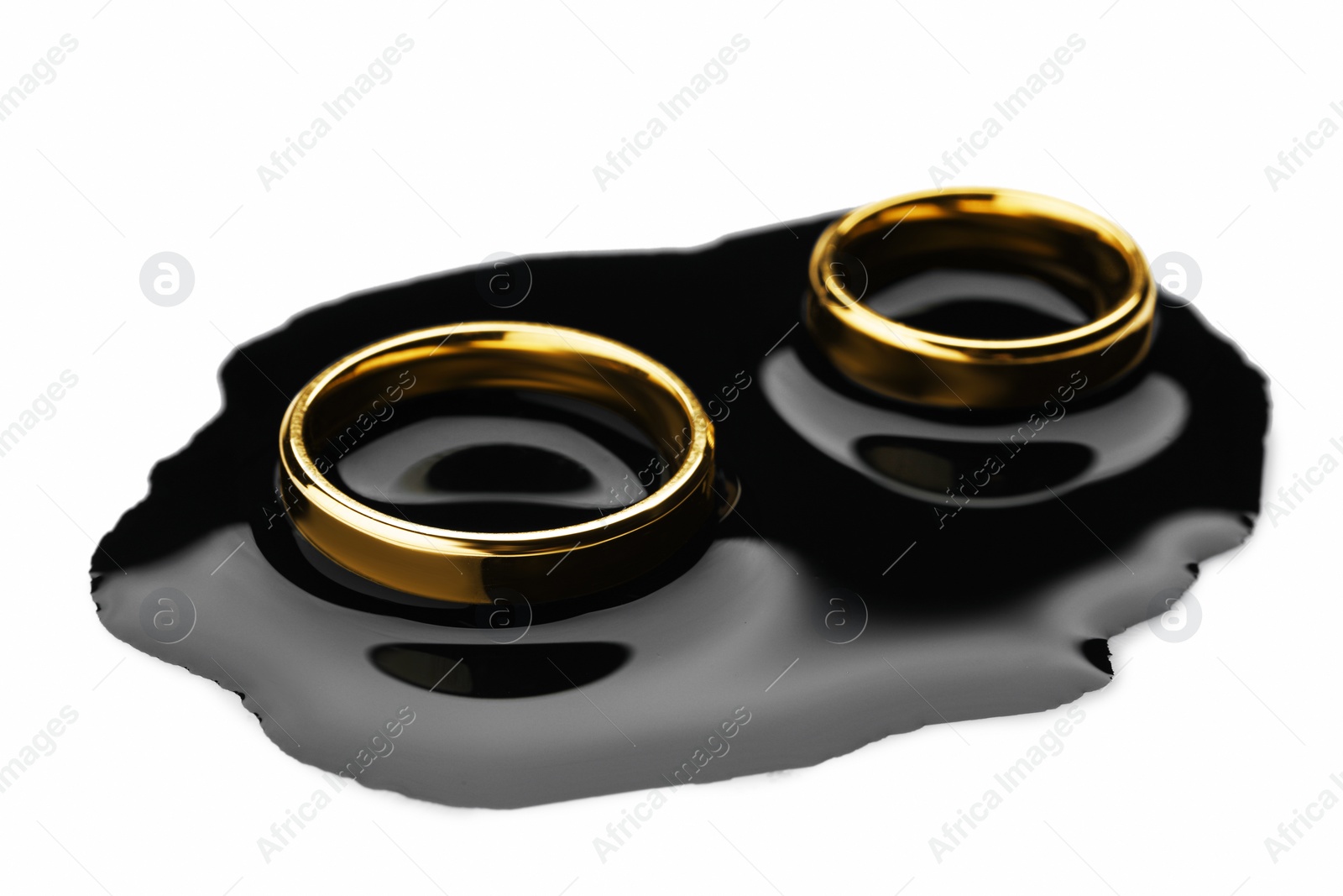 Photo of Divorce concept. Wedding rings with black ink on white background