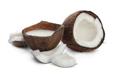 Photo of Coconut milk and cut nuts on white background