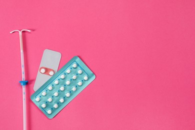 Photo of Contraception choice. Pills and intrauterine device on magenta background, flat lay. Space for text